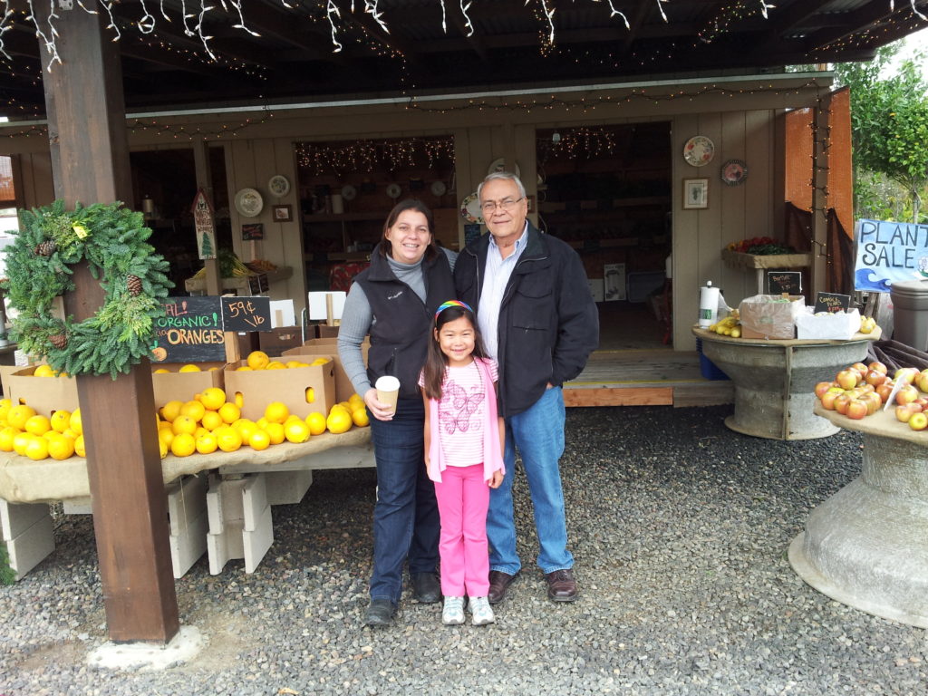 My daughter Yvonne (left), husband Rafael (right), and granddaughter Jadyn (front) at the original Daily Harvest Market. 